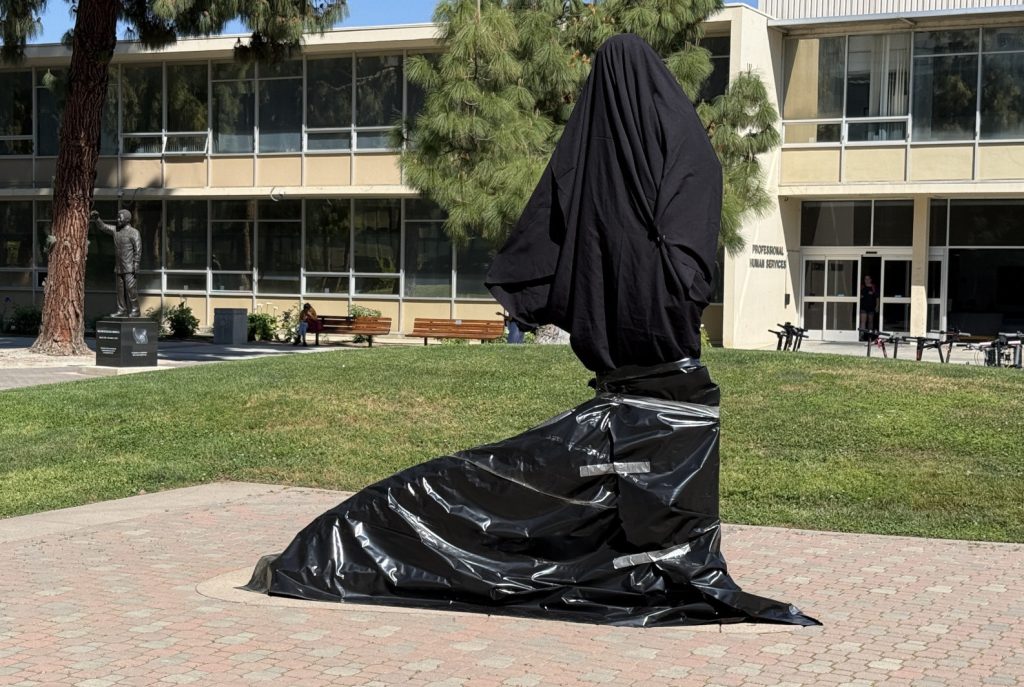 Cesar Chavez statue covered with black tarp